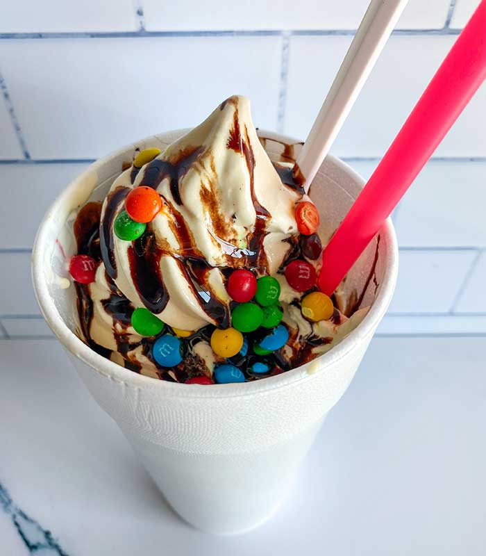Ice cream sundae with chocolate syrup and topped with candies from Fanci Freeze in Boise and Meridian Idaho.