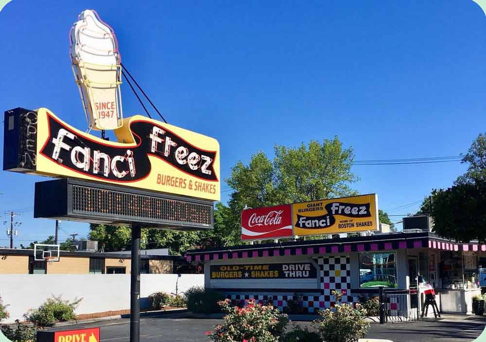 Fanci Freez drive-in restaurant sign and storefront serving soft serve milkshakes.
